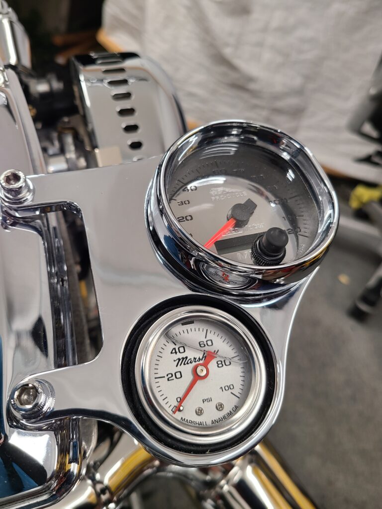 Chrome instrument cluster with speedometer and Marshall oil pressure gauge